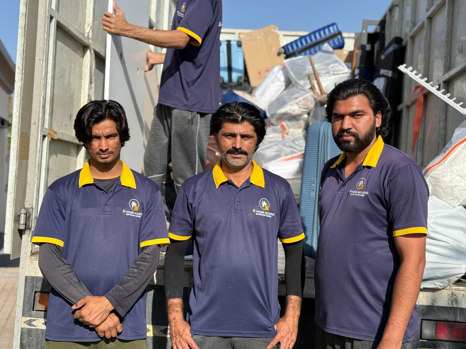 Villa movers Dubai crew in front of a fully loaded villa moving truck
